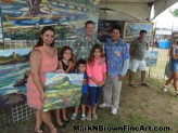 Mark N. Brown poses with this lovely family at the Haleiwa Arts Festival