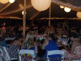 Guests enjoying the night as Hawaii Plein Air artist Mark N. Brown captures the wedding on canvas