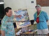Hawaii artist Mark N. Brown showcases his completed artwork that's up for auction during the Lanikai Woes Day parade
