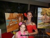 Guests of the American Heart Association Heart Ball help Mark N. Brown complete his artwork
