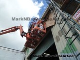 Look up! Hawaii Artist Mark N Brown and team working on the Nishimoto Trading Co Mural from the loading dock side